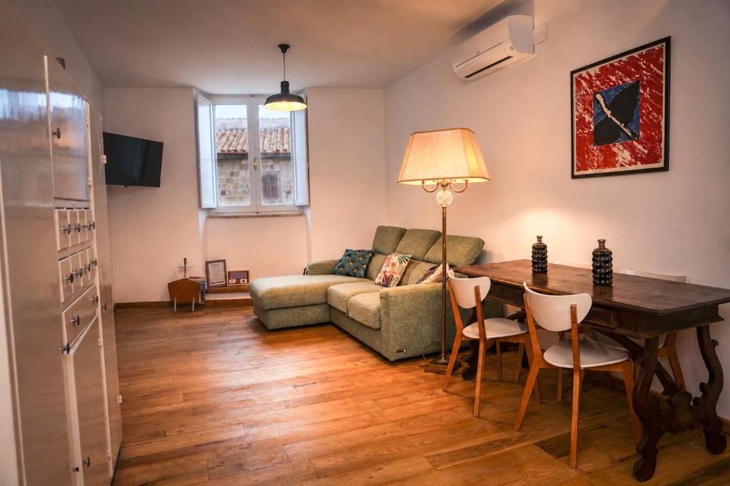 a living room with a table and a couch at Casa Elisabetta in Tuscania