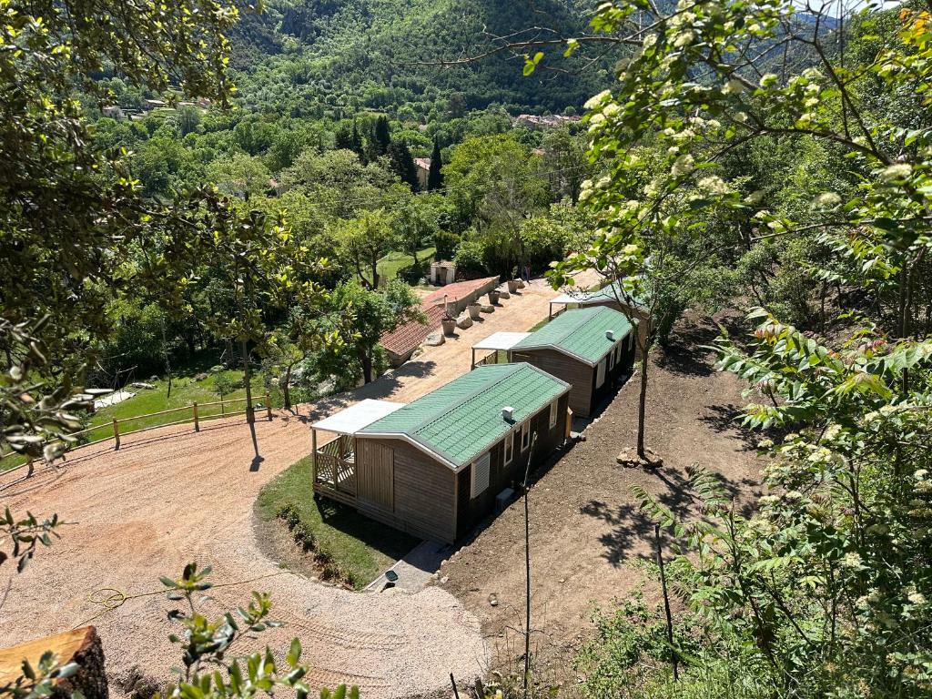 a small building with a green roof in a park at l echo du canigou in Sahorre