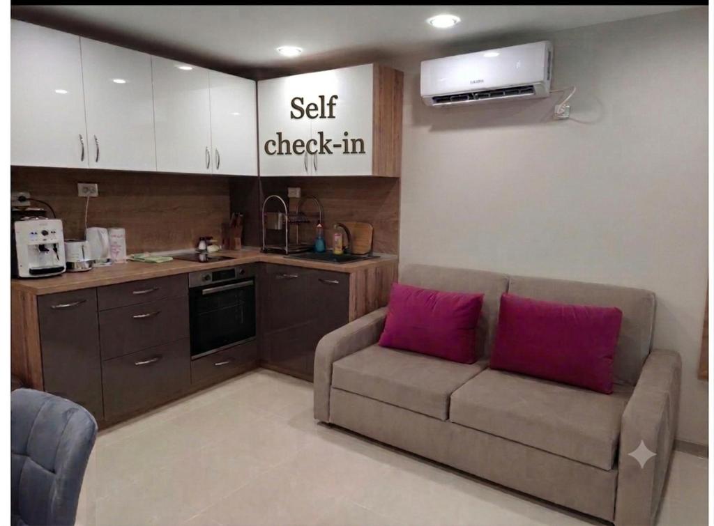 a living room with a couch and a kitchen at Downtown in Ruse