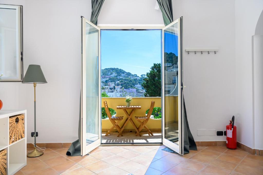 a room with a glass door leading to a dining room at Casa Ginevra Capri in Capri