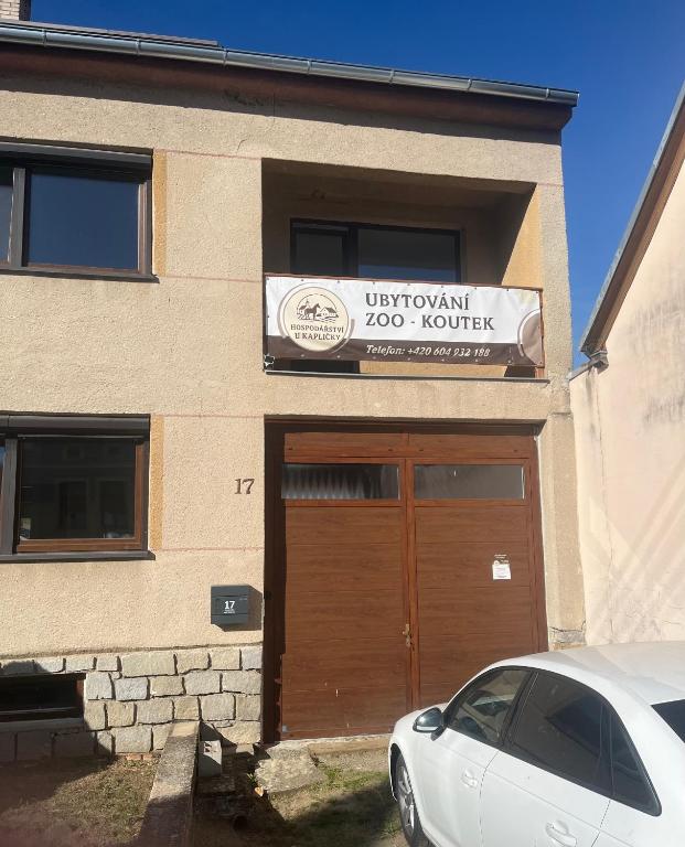 a car parked in front of a building with a garage at Hospodářství u kapličky in Kladeruby nad Oslavou