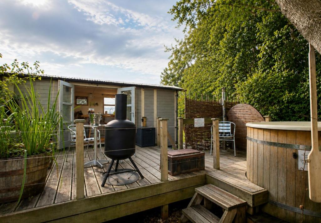 a deck with a grill and a table and chairs at The Pheasant in Great Ellingham