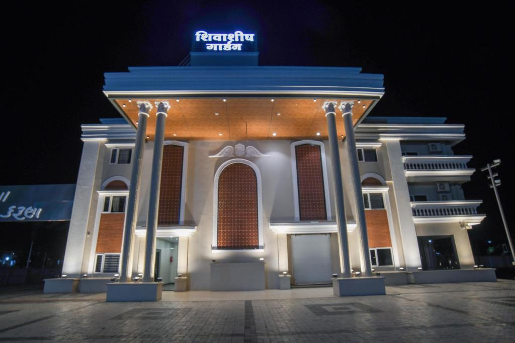 a large building with a sign on top of it at Shivashish Resort in Indore