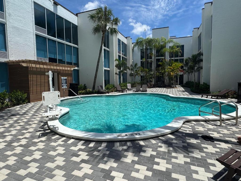 a swimming pool in front of a building at Tropical Palms Hotel in Clearwater