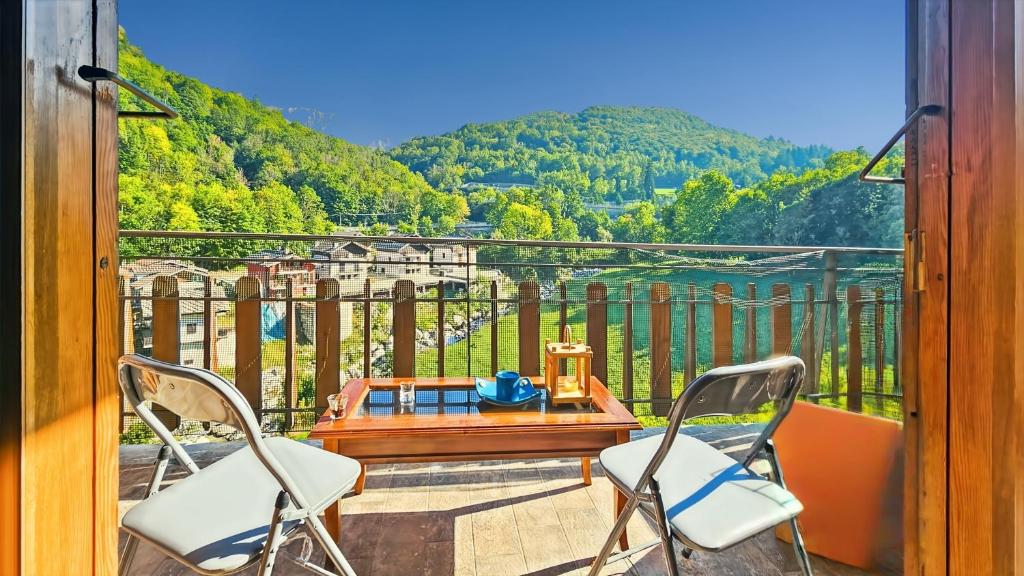 a balcony with two chairs and a table and a view at Limone Piemonte Kids Friendly in Limone Piemonte