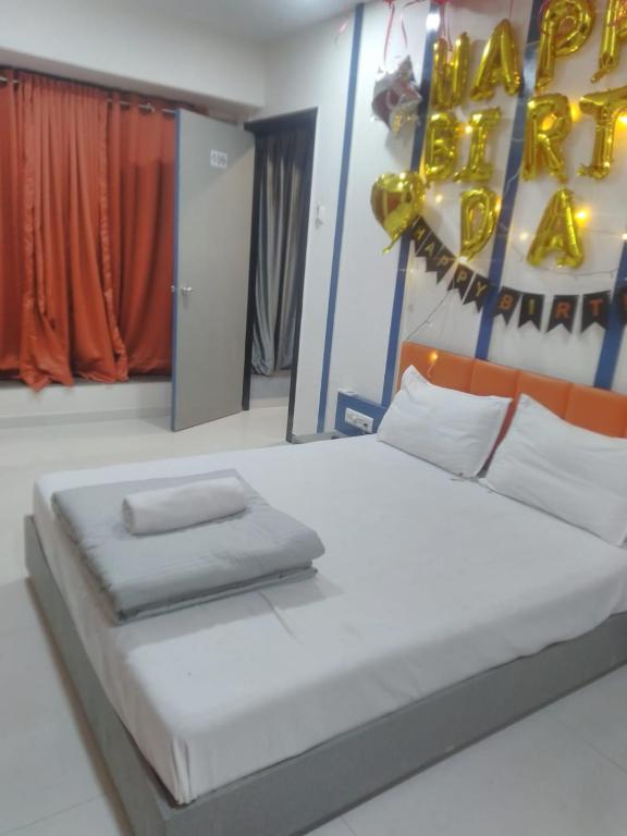 a bedroom with a large bed with a baseball sign on the wall at hotel v heritage in Surat
