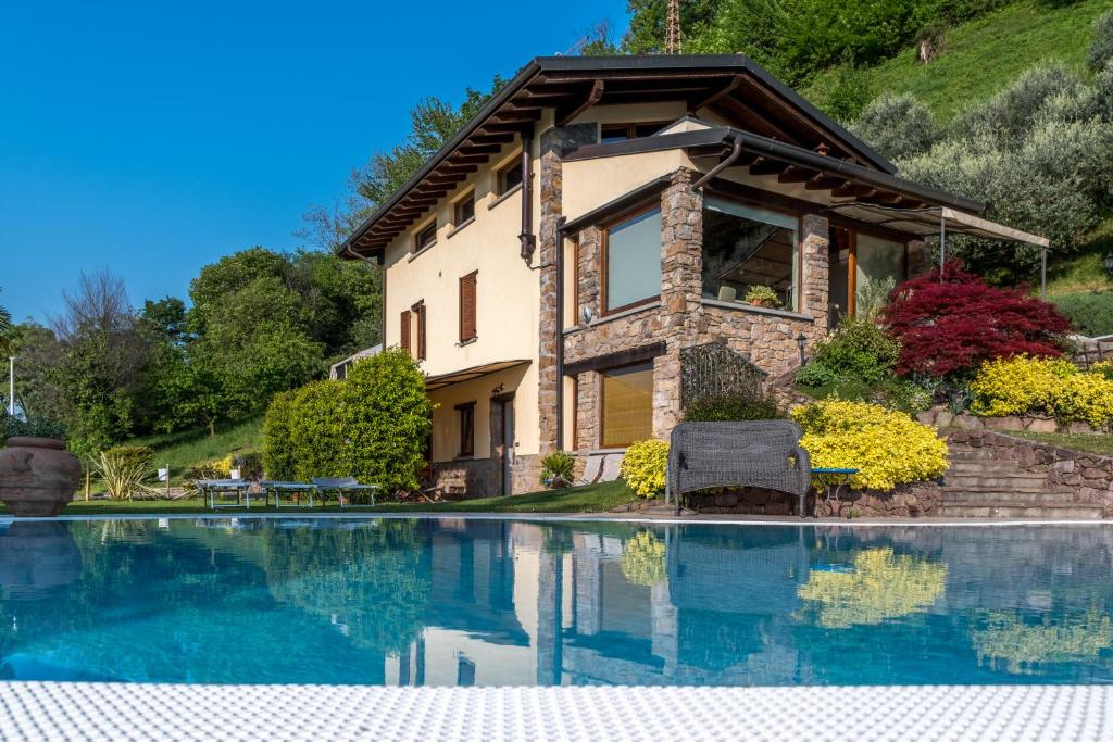 a house with a swimming pool in front of a house at Casa Ronco Frati, piscina vista lago in Pisogne