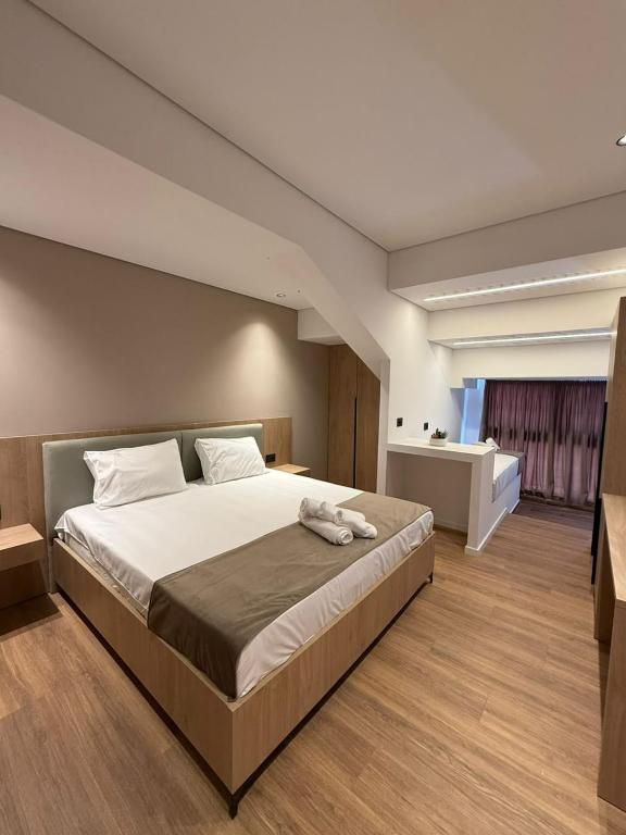 a bedroom with a large bed in a room at The Factory Boutique in Vlorë