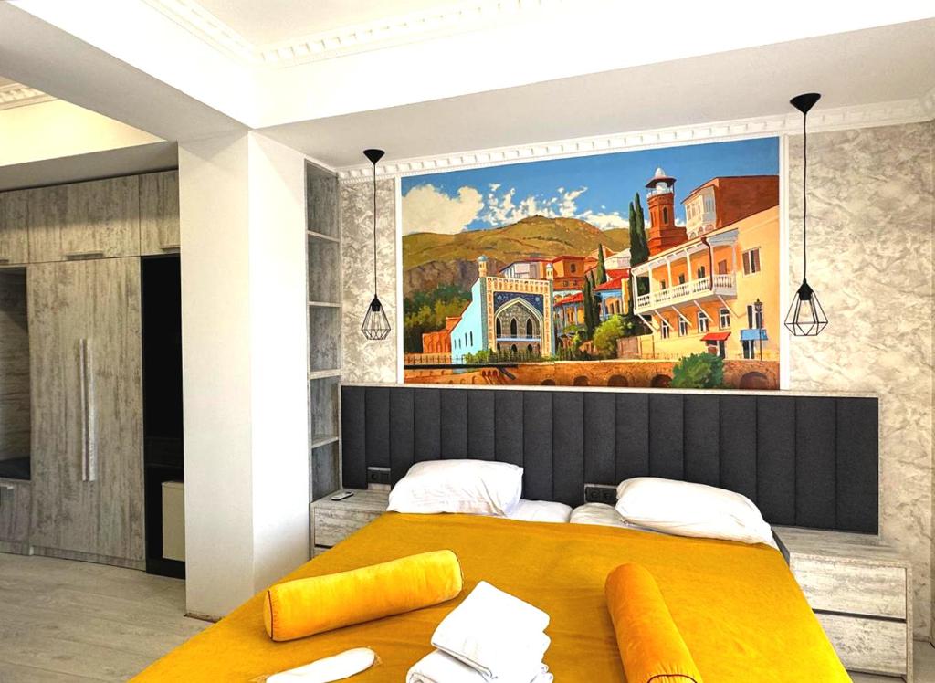 a bedroom with a large painting on the wall at 7 Baits Hotel in Tbilisi City