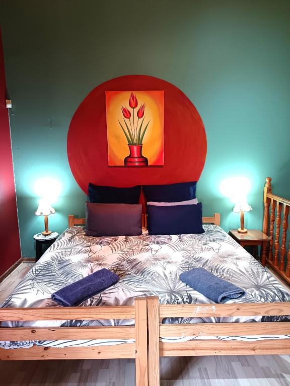 a bedroom with a large bed with a red headboard at Apartment-double storey-2 bedrooms-own bathroom, kitchen, dining room, entrance, lounge, patio in Pinetown