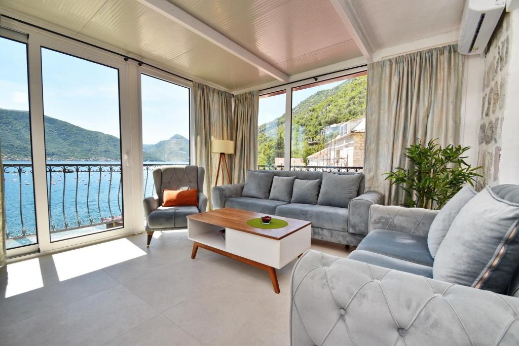 a living room with a couch and a table at Apartments Krivokapic in Perast