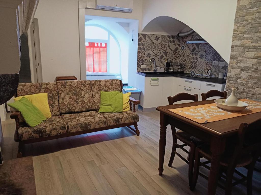 a living room with a couch and a table at Casa di nonna Caterina in Nemoli