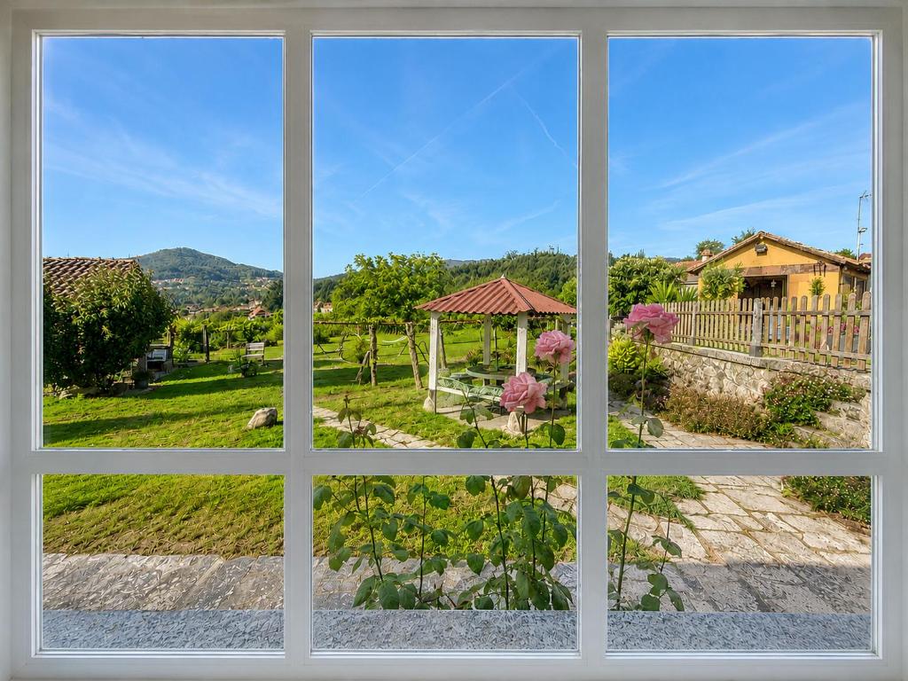 a window view of a garden from a house at Holibai Nova Anduriña, Casa rustica con jardín, Gondomar in Gondomar
