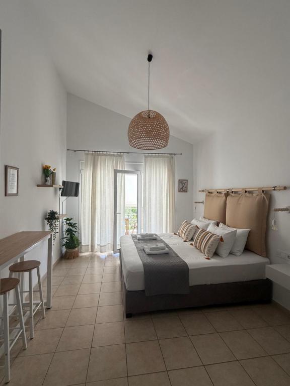 a bedroom with a bed and a bar in it at Angelos Studios in Ilia