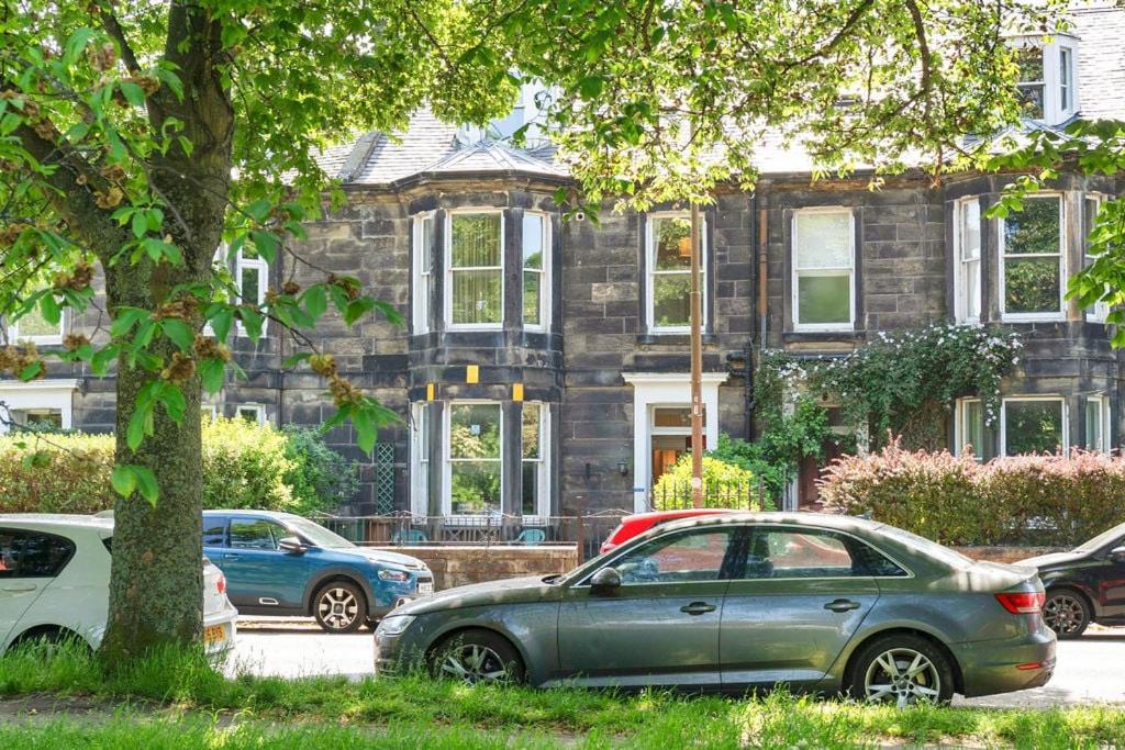 two cars parked in front of a house at GuestReady - Links View in Edinburgh