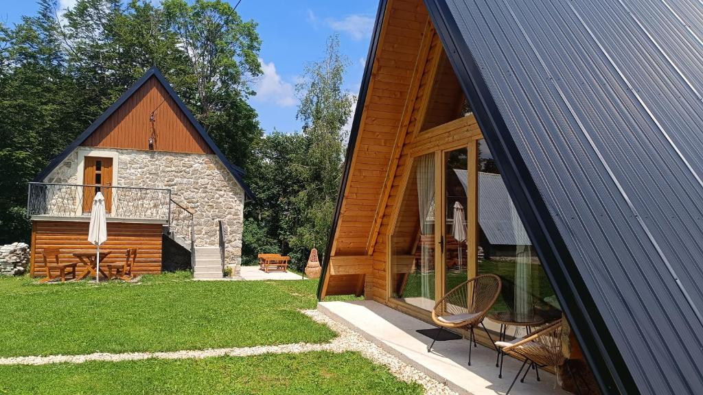 a barn conversion with a patio and a house at Mountain inn in Žabljak