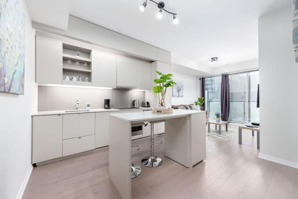 a kitchen with white cabinets and a white counter top at 1 BR plus Ent District,MTCC,Jays in Toronto