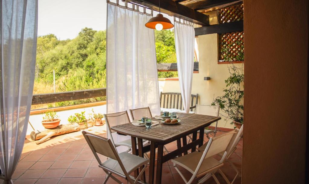 a wooden table and chairs on a patio with a view at Capalbio Relax - Super terrazza in Capalbio