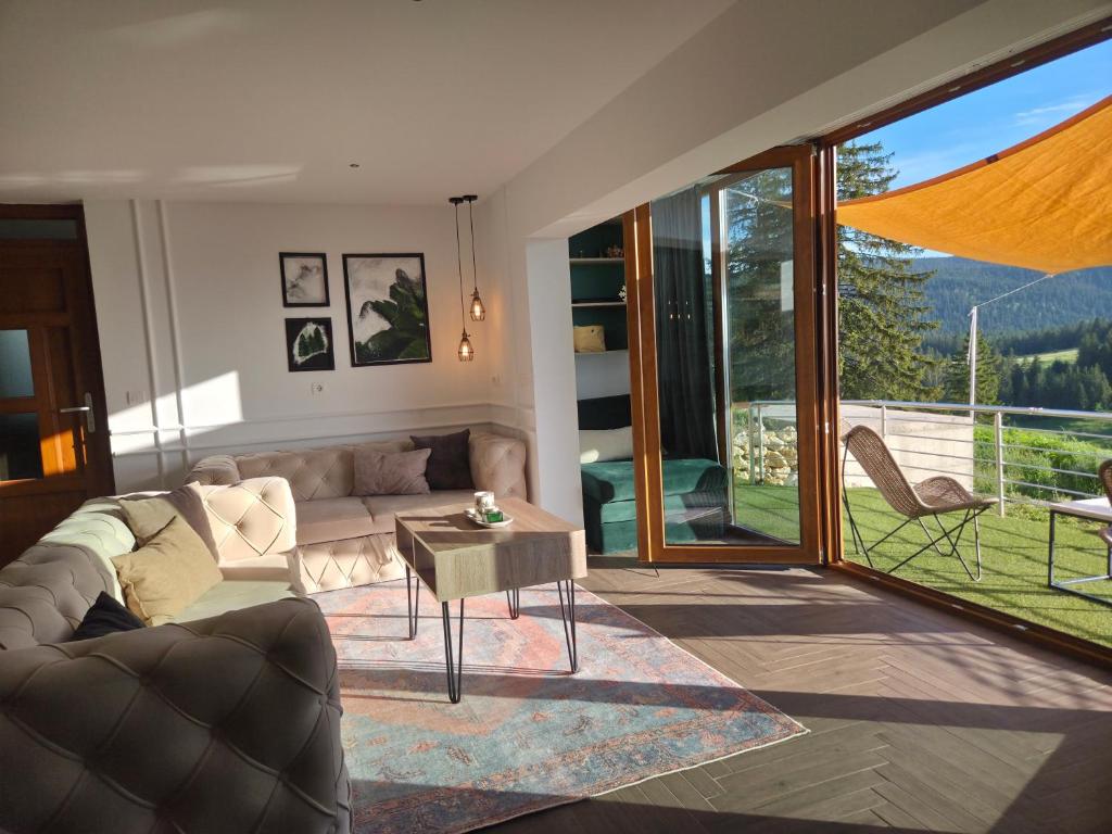 a living room with a couch and a table at Pine apartment Vlašić in Vlasic