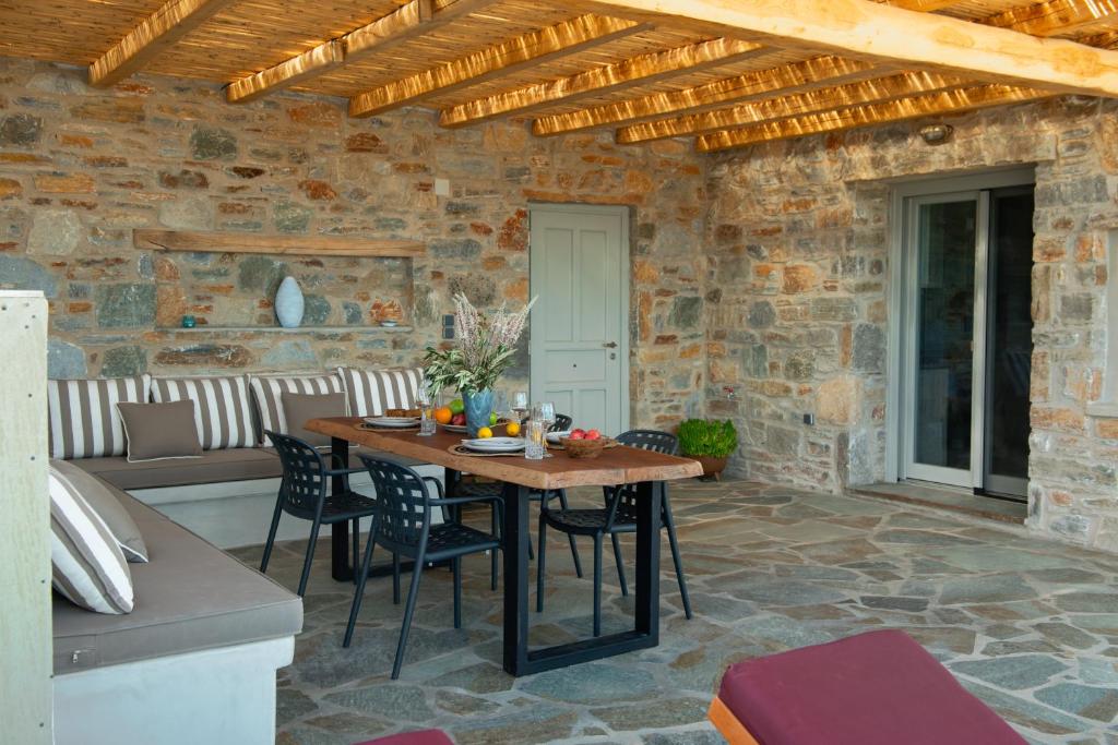 a patio with a table and chairs and a couch at Amara Serifos in Serifos Chora