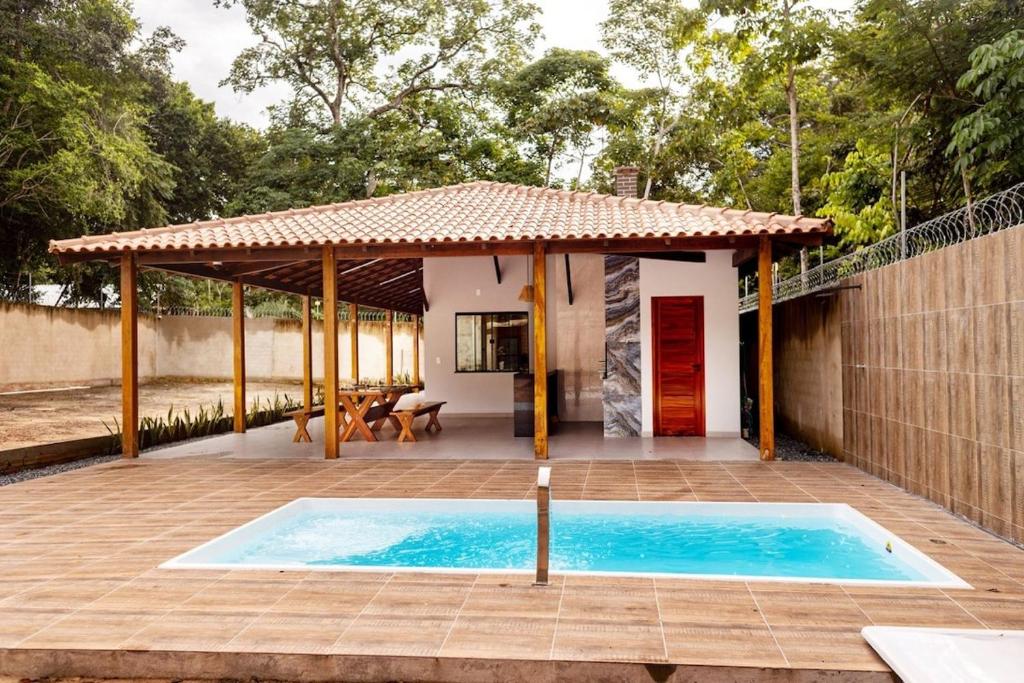 a house with a swimming pool and a gazebo at Alter Casa Sawe, Alter do Chão, PA in Santarém