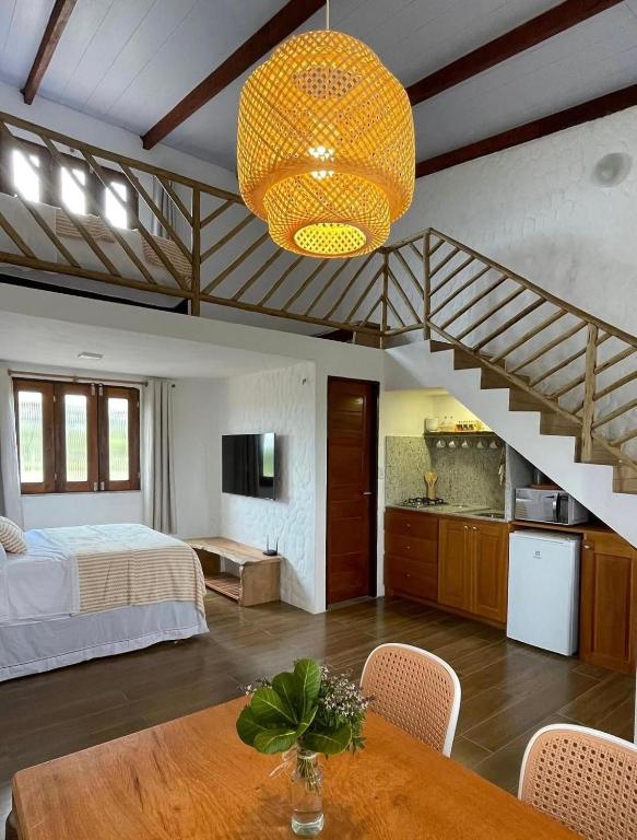 a bedroom with a bed and a staircase at Chalé Brisa do Rio in Paulino Neves