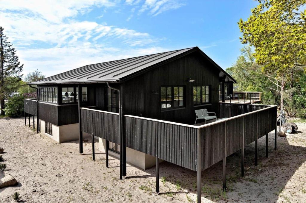 a black house with a black roof at 8569-Grenaa-Kystvej-3-b in Grenå Strand