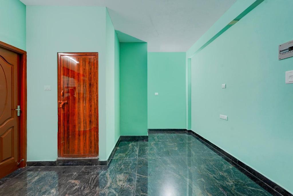 an empty room with a door and a tile floor at Hotel O White Inn in Chennai