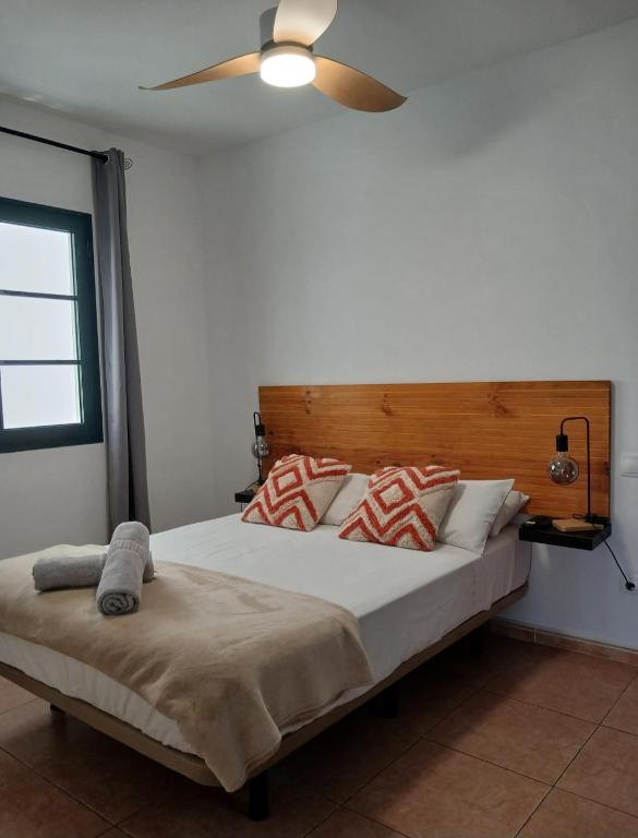 a bedroom with a large bed with a ceiling fan at Apartamento Stefi in Arrecife