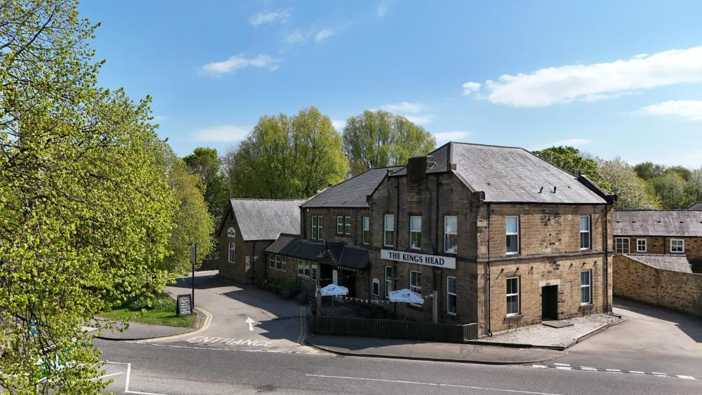 an old brick building on the side of a street at The King's Head, Lanchester in Durham