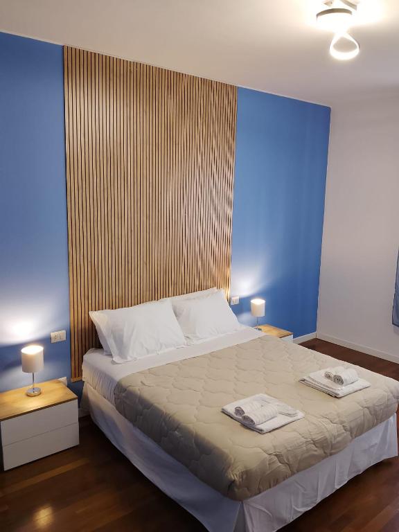 a bedroom with a large bed with two towels on it at Beautiful Home Mxp in Gallarate