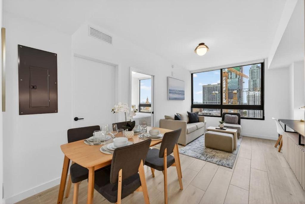 a dining room and living room with a table and chairs at Downtown Miami Luxe 1BR! in Miami
