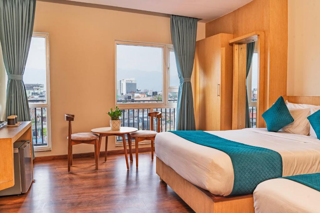 a hotel room with a bed and a balcony at Marlo Hotels in Kathmandu