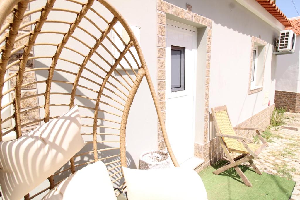 a swing on the porch of a house at Little Paradise in Castro Marim