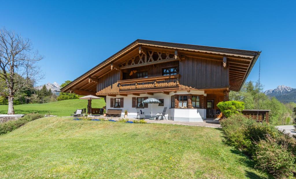 a large house with a wooden roof on a hill at Jägers Highlineblick in Breitenwang