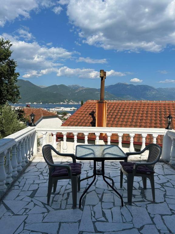a patio with a table and two chairs on a roof at E&L Apartments in Kovačina
