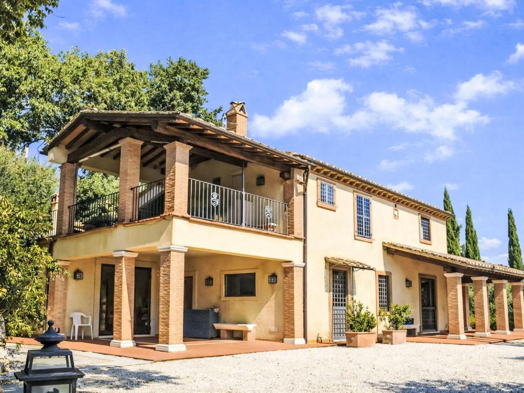 an exterior view of a house with a balcony at Villa Le More by Interhome in Penna in Teverina