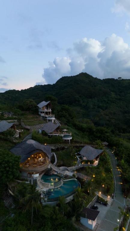 an aerial view of a resort with a swimming pool at Green Poya - Luxury Eco Bambu Resort in South Lombok in Selong Belanak