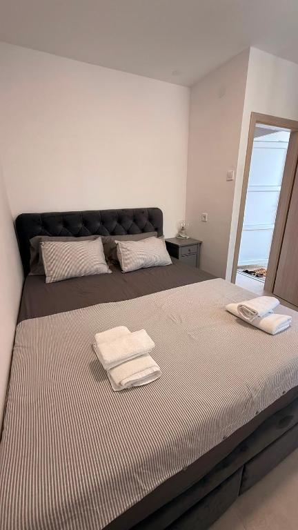 a bedroom with a large bed with two towels on it at Kazeta A-14,broj 28, Gajac in Skunca
