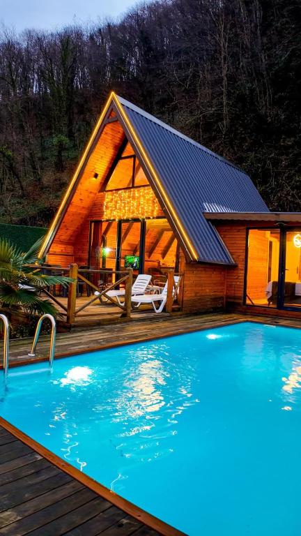 a house with a swimming pool in front of it at Vice Suit Bungalov in Sapanca