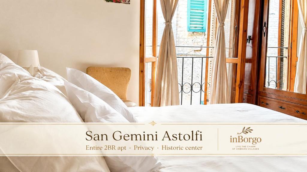 a bed in a room with a window at San Gemini Astolfi - InBorgo in San Gemini
