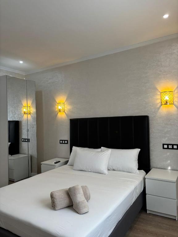 a bedroom with a large white bed with two towels on it at Boutique Princesa in Marbella