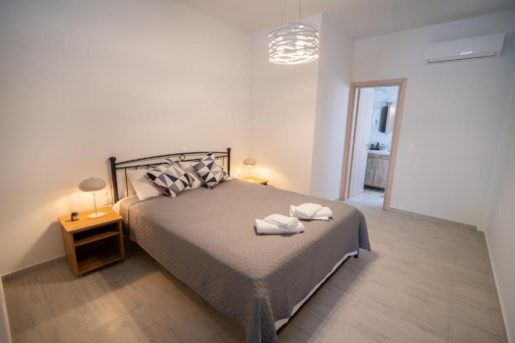 a bedroom with a bed with two towels on it at Studios Kerasioti in Pefki