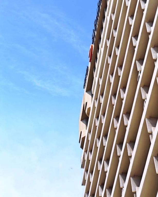 a building with balconies against a blue sky at The 5 Elements Hotel Chinatown Kuala Lumpur in Kuala Lumpur