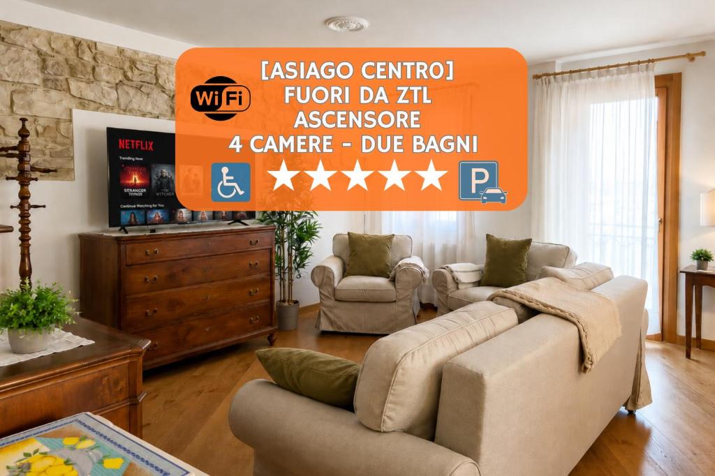 a living room with two couches and an orange sign at Lhousing - Ideale per Famiglie e Gruppi in Asiago