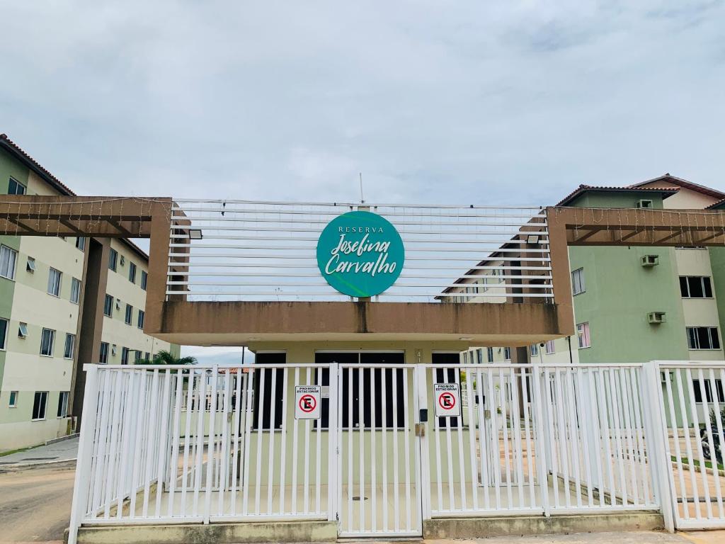 a building with a white gate in front of it at Day aconchego in Aracaju