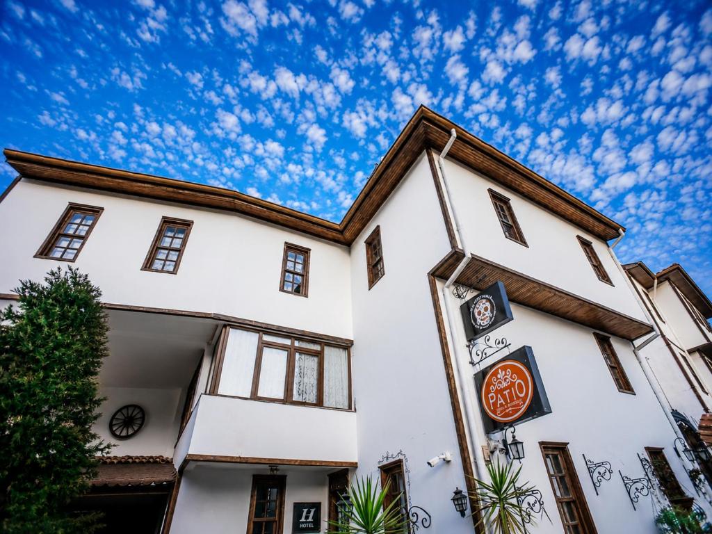 a white building with a blue sky in the background at Oldtown Patio in Antalya
