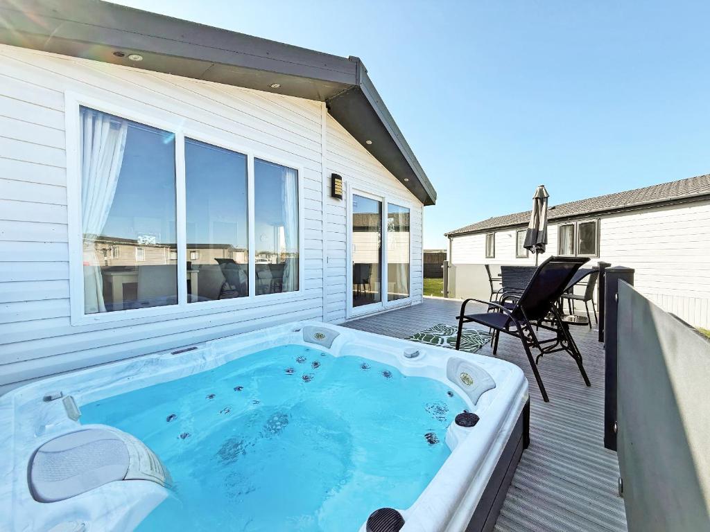 a hot tub on the deck of a house at The Retreat 22 - Ukc9564 in Ingoldmells