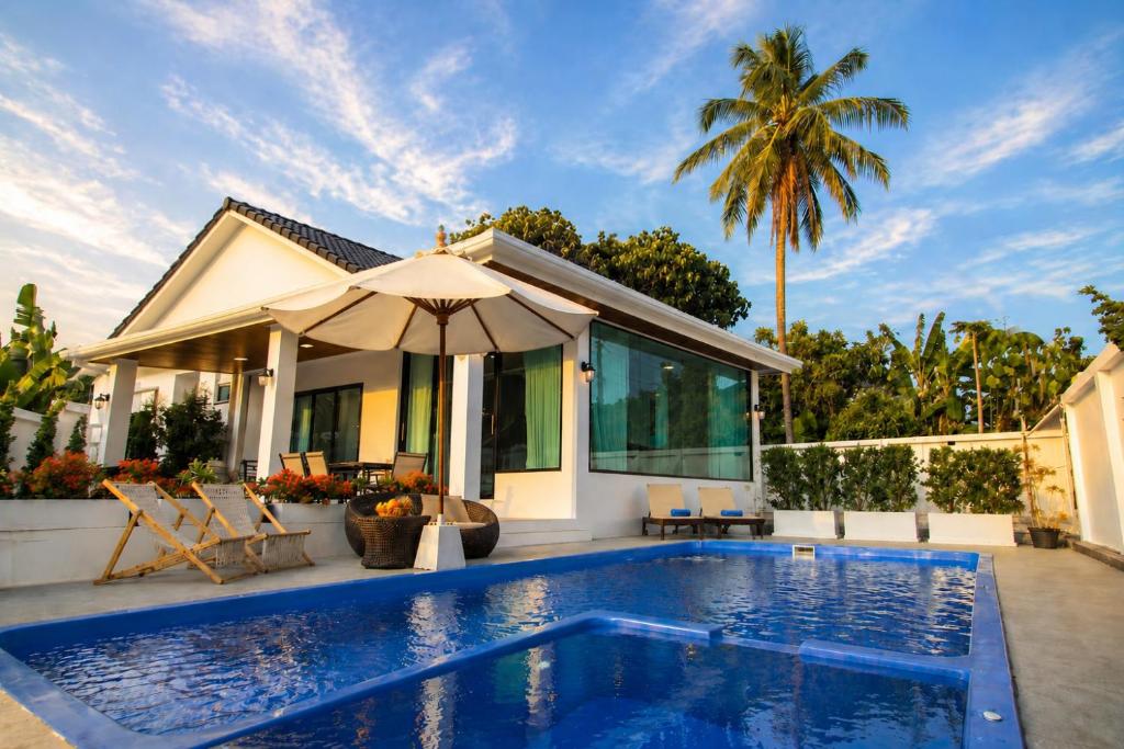 a villa with a swimming pool and a house at Sunset Pool Villa Ao Nang Krabi in Ao Nang Beach