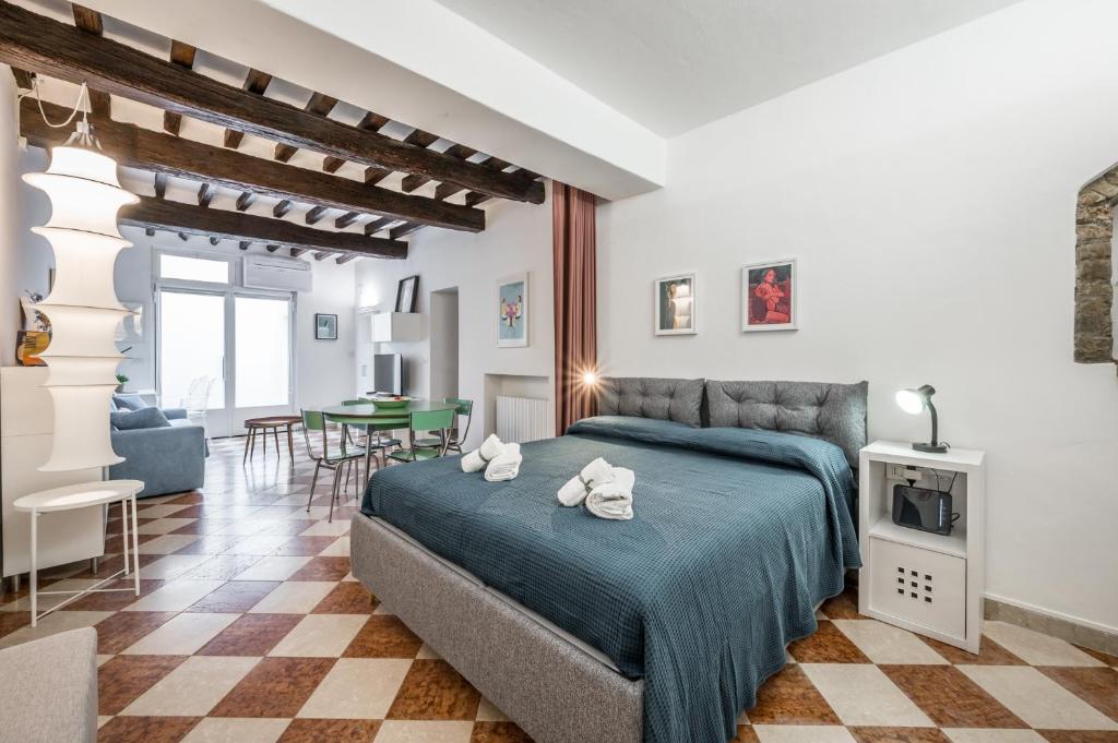a bedroom with a bed and a living room at Casa Camilla - Arty Suite nel centro storico in Parma